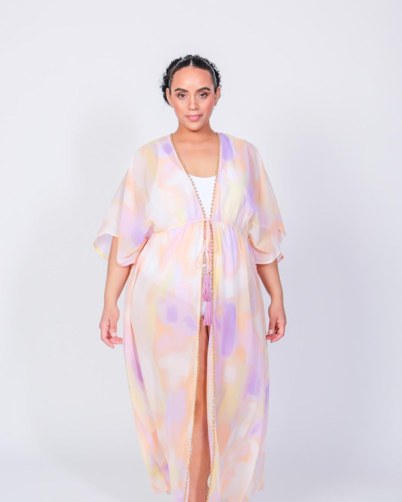 Front of a model wearing a size L (12/14) Taffy Maxi Duster in Cotton Candy Print by LuvMeMore. | dia_product_style_image_id:266700